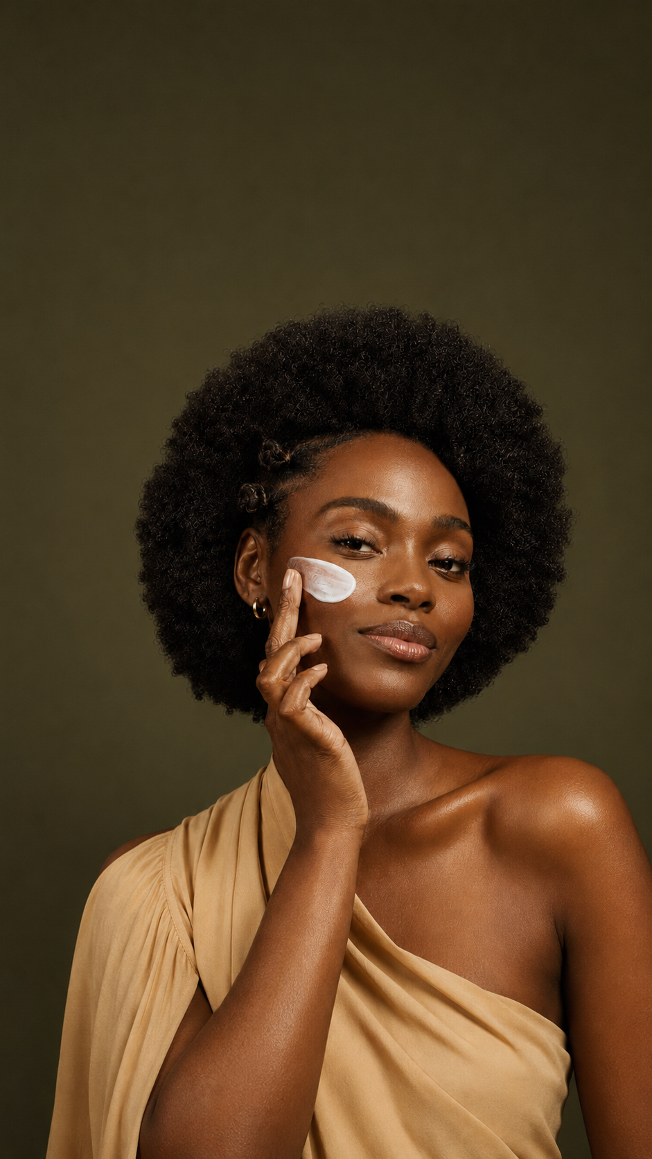 A woman applying skincare cream to her cheek